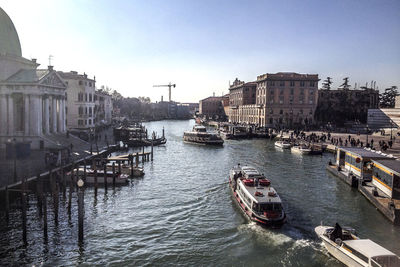 View of boats in city against clear sky