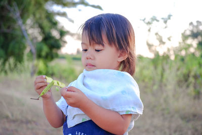 Cute girl holding plant