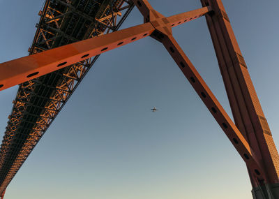 Low angle view of red bridge against clear sky