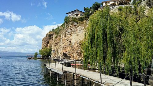 Scenic view of lake by building against sky