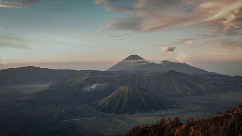 View of volcanic landscape against cloudy sky