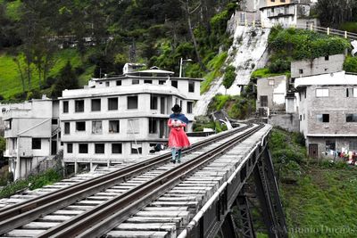 Rear view of person standing on railroad track