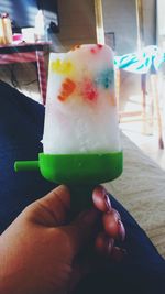 Close-up of hand holding ice cream