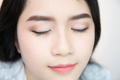 Close-up of young woman wearing make-up