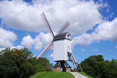 Low angle view of traditional windmill against sky