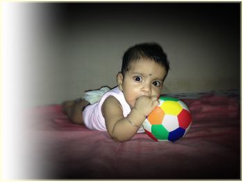 Portrait of boy playing with ball