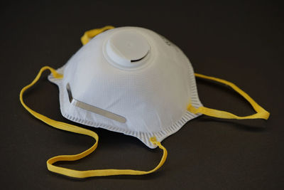 High angle view of yellow paper on table against black background