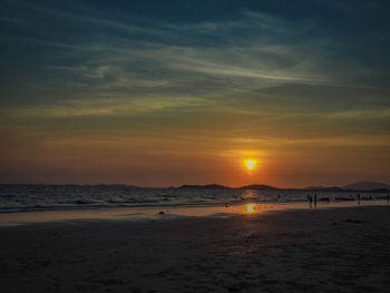 Scenic view of beach against sky during sunset