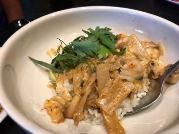 High angle close-up of rice with snapper curry served in plate