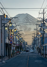 Street amidst buildings against mt fuji