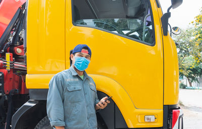 Man standing in yellow bus