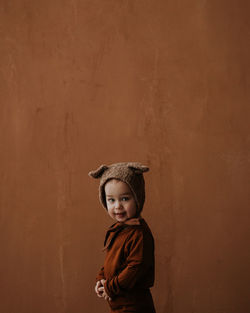 Toddler baby boy in funny costume with ears looking at the camera