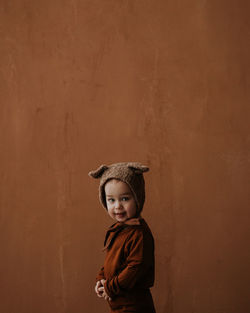 Toddler baby boy in funny costume with ears looking at the camera