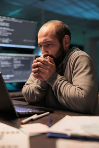 Young man using laptop at office