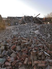 Stack of garbage in construction site against sky