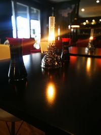 Illuminated tea light candles on table in restaurant