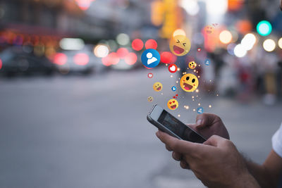 Cropped hand of woman using mobile phone