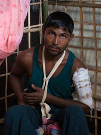 Portrait of young man sitting outdoors