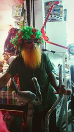 Man holding carousel at amusement park