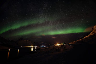 Scenic view of lake against sky at night