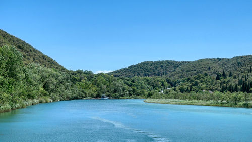 Scenic view of skradinski buk against clear blue sky