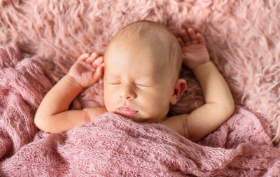 Baby girl sleeping on bed