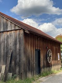 Old barn on field against building