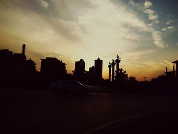 Silhouette buildings at sunset