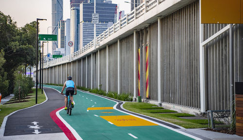 Man riding bicycle on road in city