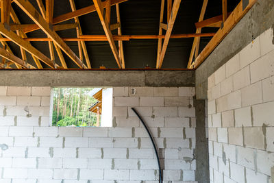 Roof trusses covered with a membrane on a detached house under construction, visible roof 