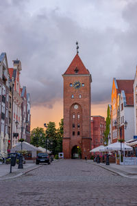 Street amidst buildings in city against sky