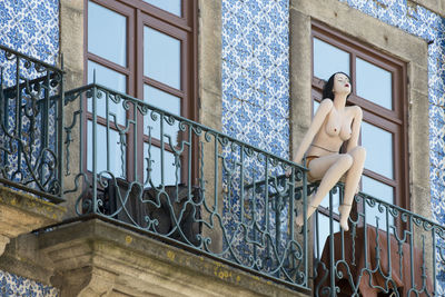 Low angle view of mannequin on balcony