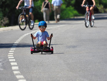 Full length of boy riding segway on road