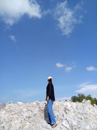 Woman standing on a pile of white sand