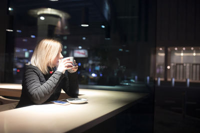 Man looking at illuminated camera