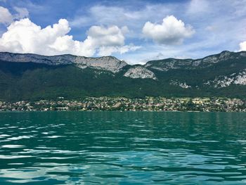 Scenic view of sea and mountains against sky