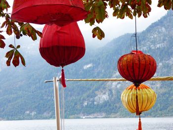 Low angle view of lanterns hanging against sky