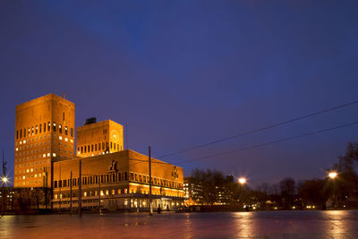 Illuminated buildings against sky at night