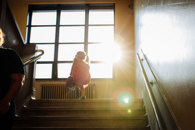 Girl going to first day of school walking up stairs