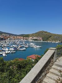 Sailboats in sea against clear blue sky