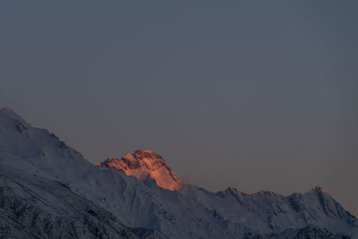 Scenic view of snowcapped mountains against clear sky