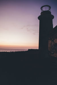 Silhouette built structure against sky during sunset