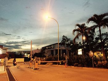 Street against sky at sunset