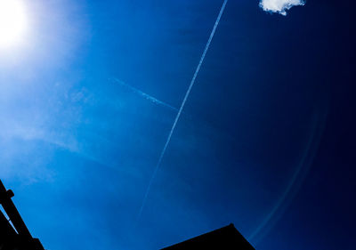 Low angle view of vapor trail in blue sky