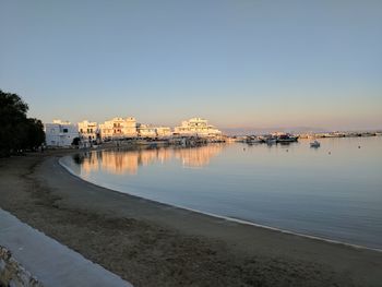 View of city at waterfront during sunset