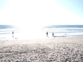 View of calm beach against clear sky