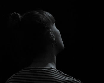 Rear view of woman against black background