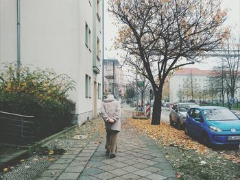 People walking on footpath in city