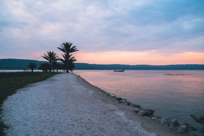 Scenic view of beach against sky during sunset