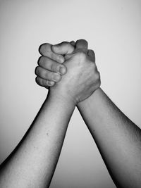 Close-up of hands against white background